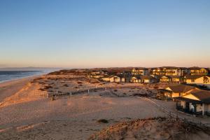 a view of a beach with houses and the ocean at Sanctuary Beach Resort in Marina