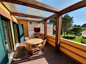 a patio with a table and chairs on a balcony at Big Fish 1 - Charming Beach Apartment in Praia de Mira