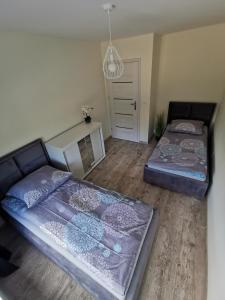 Pokój z 2 łóżkami, kanapą i drzwiami w obiekcie mikroKlimat Apartamenty Mielno w Unieściu
