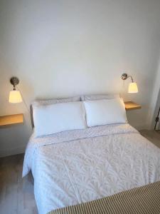 a bedroom with a bed with two lights on it at Room 3 Camp Street B&B in Oughterard