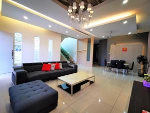 a living room with a couch and a coffee table at Warni Villa 13 Whole Or Room in Muar