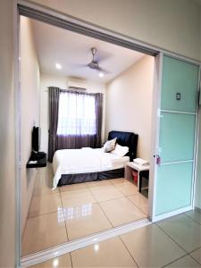 a bedroom with a bed and a sliding glass door at Warni Villa 13 Whole Or Room in Muar