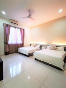 a bedroom with two beds and a window at Warni Villa 13 Whole Or Room in Muar