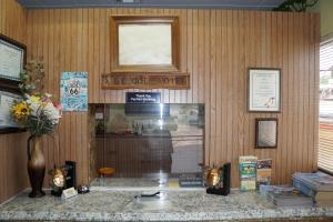 a room with a wooden wall with a counter at Lincoln Motel in Chandler