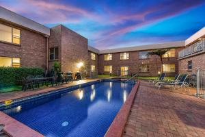 a swimming pool in the backyard of a house at Southgate Motel in Mount Gambier