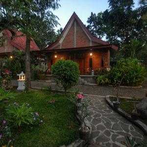 a house with a pathway in front of it at Omah Joglo Semarang in Semarang