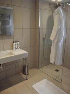 a bathroom with a shower and a sink at The Suites at Pannells Ash in Castle Hedingham