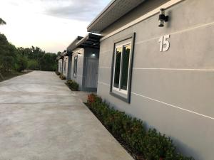 a sidewalk next to a building with a number on it at Relax Resort in Nakhon Sawan