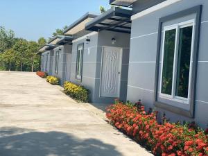 a building with flowers on the side of it at Relax Resort in Nakhon Sawan