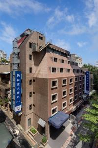 a building with a sign on the side of it at K Hotel Taipei in Taipei