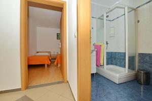 a bathroom with a shower and a bedroom at Apartments Blaza in Božava +84 photos