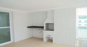 a kitchen with white tiled walls and a stove at AP Padrão Pé na Areia Centro TOP TODO COM AR CONDICIONADO in Mongaguá
