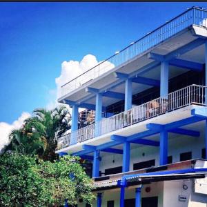 a blue building with a balcony on top of it at Iconic Rawana Resort in Ella