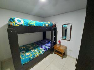 1 dormitorio con 2 literas y espejo en Apartamentos YNJ, en Bogotá