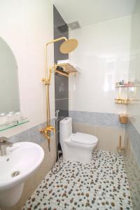 a bathroom with a white toilet and a sink at Thanh Binh Hotel Con Dao in Con Dao