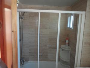 a shower in a bathroom with a toilet at Costa Dorada Miami in Miami Platja +14 photos