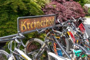 Ein Haufen Fahrräder, die neben einem Schild geparkt sind. in der Unterkunft Landhotel Kreinerhof in Möllbrücke