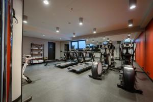 a gym with several treadmills and machines in it at Novotel Regensburg Zentrum in Regensburg