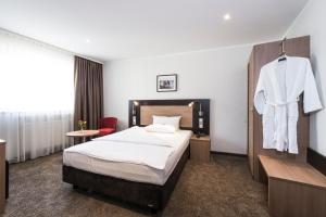 Postel nebo postele na pokoji v ubytování Astor & Aparthotel