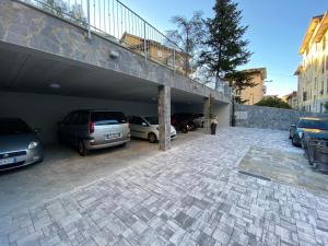 a parking lot with cars parked in a garage at Millstone House in La Spezia