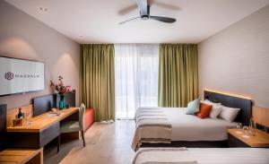 A bed or beds in a room at Magdala Hotel