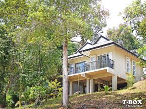 a house on top of a hill with trees at T-Box Sungai Lembing in Sungai Lembing