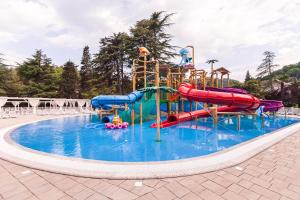 a pool with a water park with a water slide at Alean Family Resort & SPA Sputnik 4* Ultra All Inclusive in Sochi