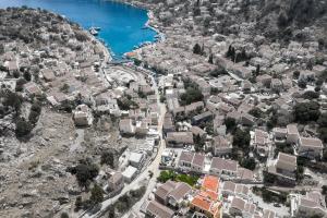 an aerial view of a town on a hill at Grace Hotel & Studios in Symi