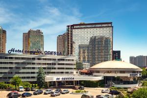 a city with cars parked in a parking lot at OK Odessa in Odesa