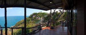 a house with a view of the ocean from a balcony at Moondance Magic View Bungalow in Ko Tao