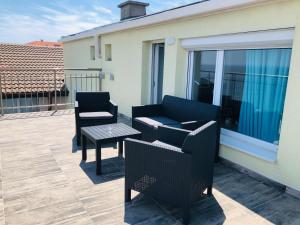 a patio with two chairs and a table on a balcony at Hotel Nikola in Primorsko