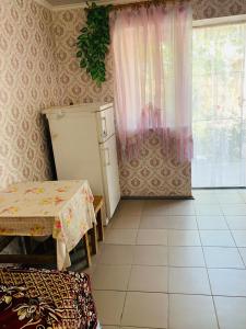 a kitchen with a table and a refrigerator in a room at Novaya Dacha in Kurortne +47 photos