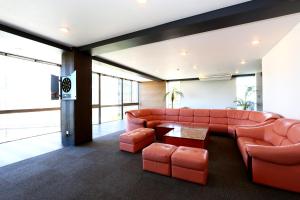 a living room with a couch and a table at OceanFront YAHAN in Shimoda