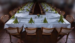 a long table with white table cloth and chairs at Hotel Dorheimer Hof in Friedberg