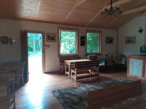 a living room with a table and some windows at Agroturystyka GAGA in Ustka