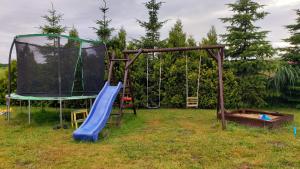 a playground with a slide and a swing set at Willa Wega in Sianozety