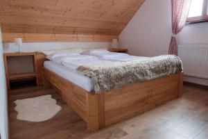 a bedroom with two beds and a wooden ceiling at Chata Marguška - U Fera in Oščadnica