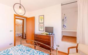 a bedroom with a bed and a dresser and a mirror at Villa Orchidea in Torre Santa Sabina