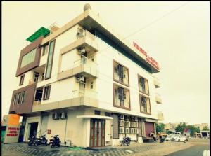 a building with motorcycles parked in front of it at Vinayak Inn Hotel in Jaipur