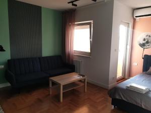 a living room with a couch and a table at TiTo in Belgrade