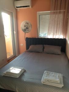 a bedroom with a bed with two towels on it at TiTo in Belgrade
