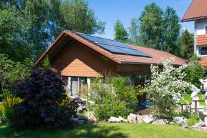 a house with solar panels on the roof at Waldgasthaus am Schwarzenbruch in Allenbach +87 photos