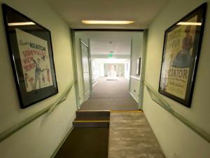 a hallway with two posters on the walls of a building at Hollywood Celebrity Hotel in Los Angeles