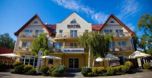 a hotel with a sign on the front of it at Hotel Nadmorski in Łeba