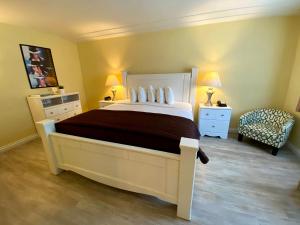a bedroom with a large bed and a chair at Hollywood Celebrity Hotel in Los Angeles