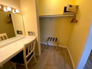 a bathroom with a sink and a mirror and a table at Hollywood Celebrity Hotel in Los Angeles