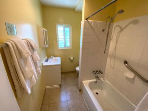 a bathroom with a tub and a sink and a toilet at Hollywood Celebrity Hotel in Los Angeles