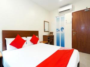 a bedroom with a large white bed with red pillows at Near Jonker Street - JCITYHOTEL - FREE PARKING in Malacca