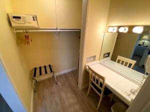 a small room with a table and a mirror at Hollywood Celebrity Hotel in Los Angeles