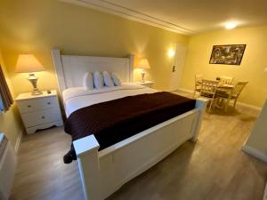 a bedroom with a large bed and a table at Hollywood Celebrity Hotel in Los Angeles
